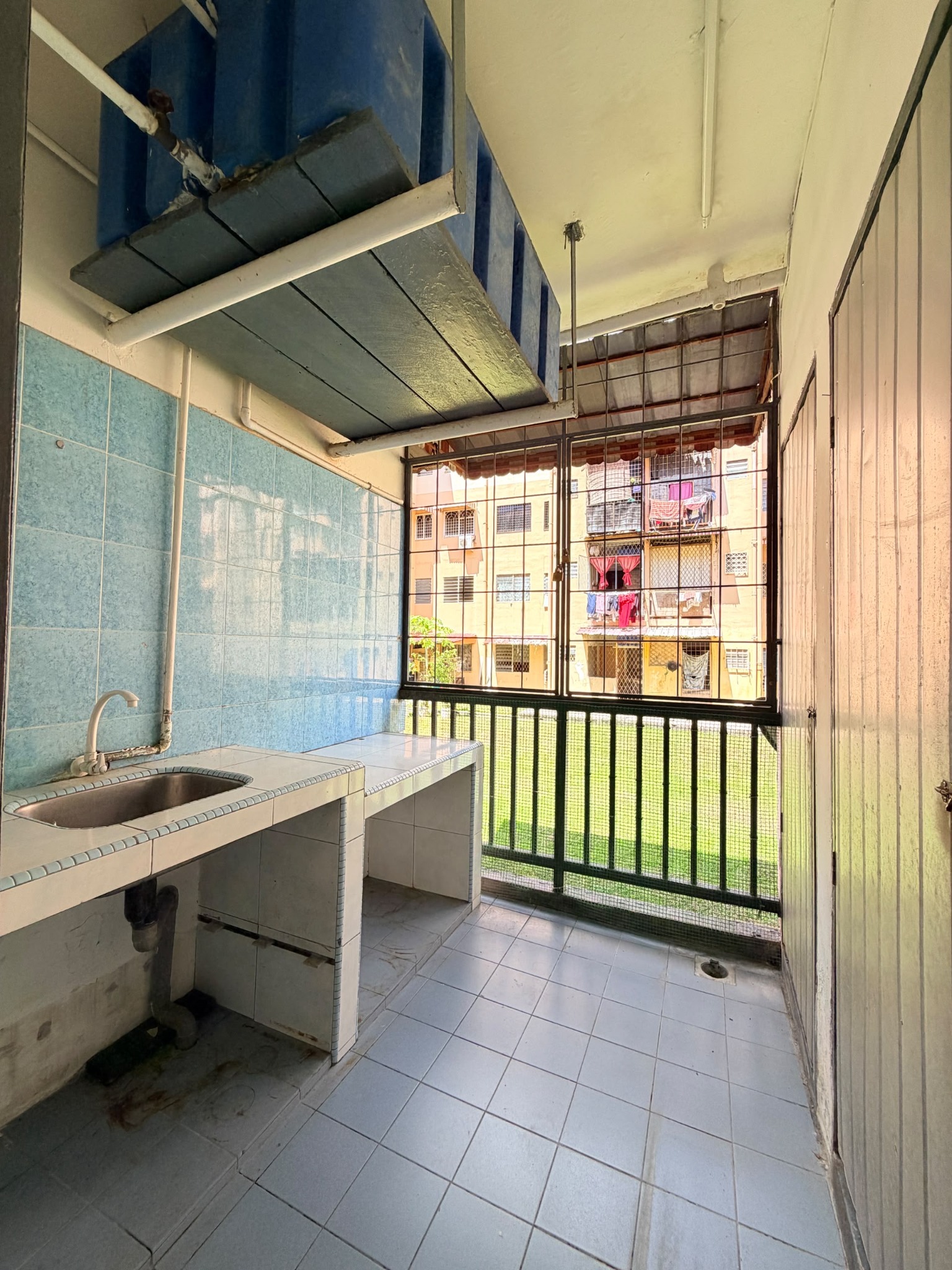Kitchen and utility area at Telipok Ria Apartment