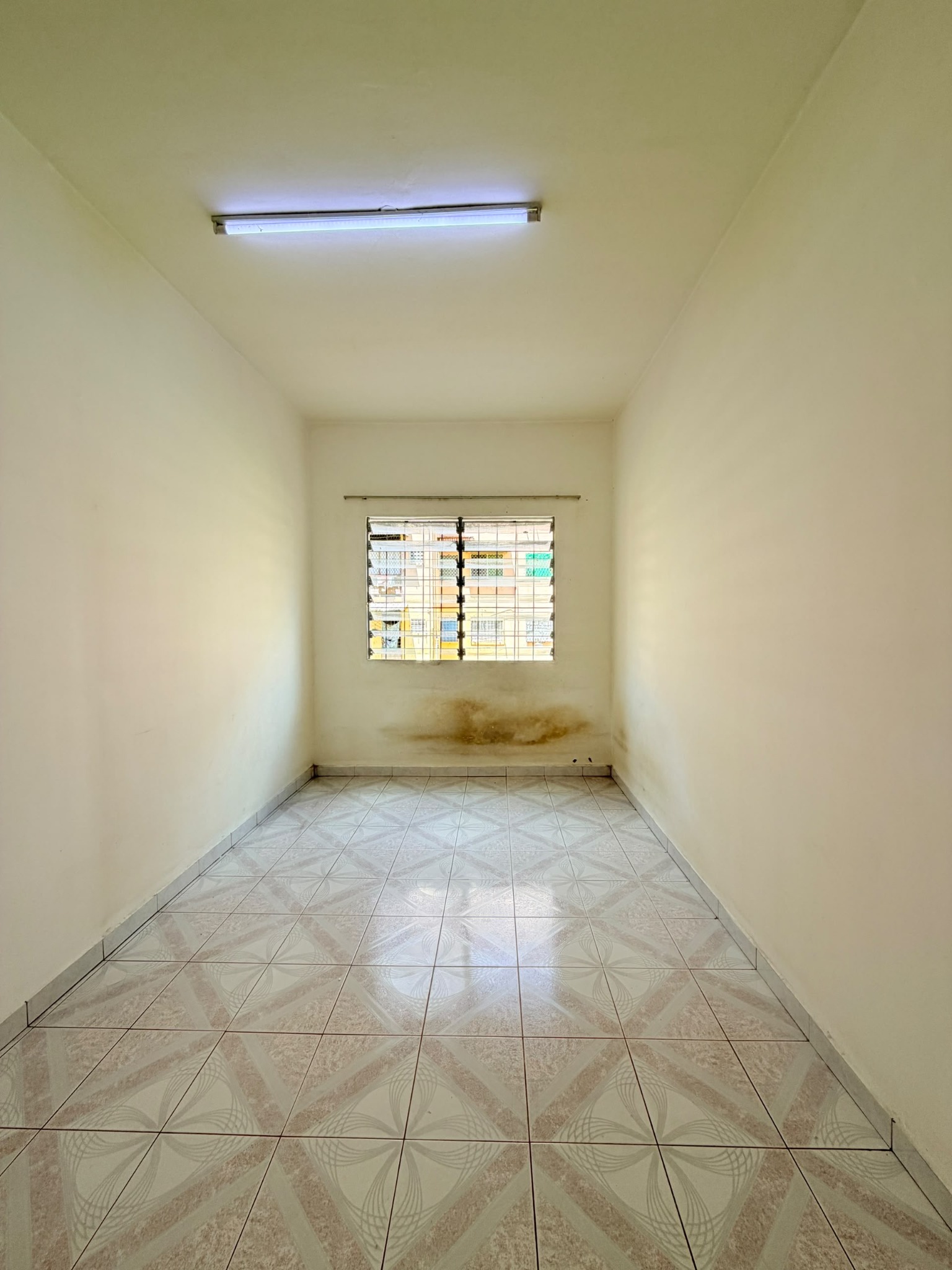 Long bedroom with window at Telipok Ria Apartment