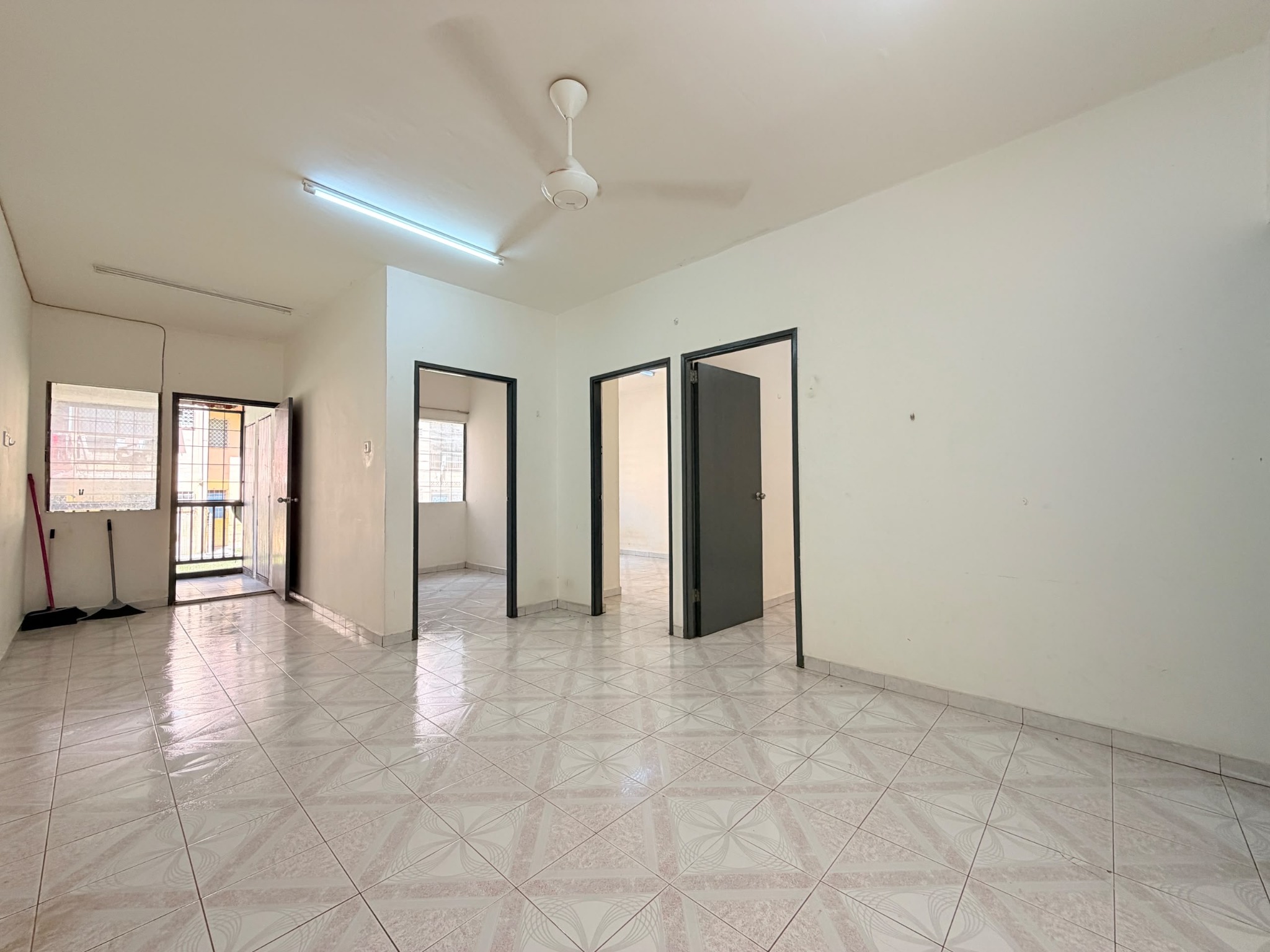 Living area and bedroom entrances at Telipok Ria Apartment